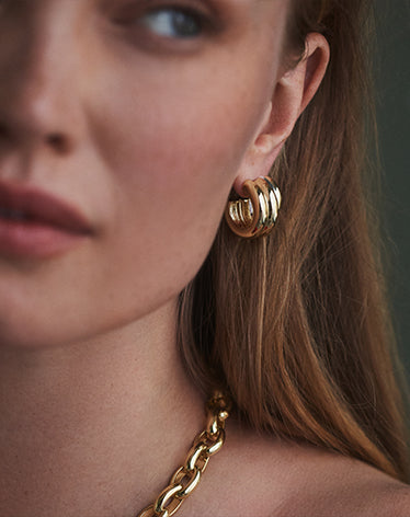 Woman wearing stacked hoop earrings