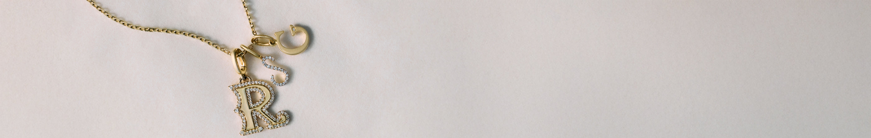 Solid gold and diamond alphabet charms