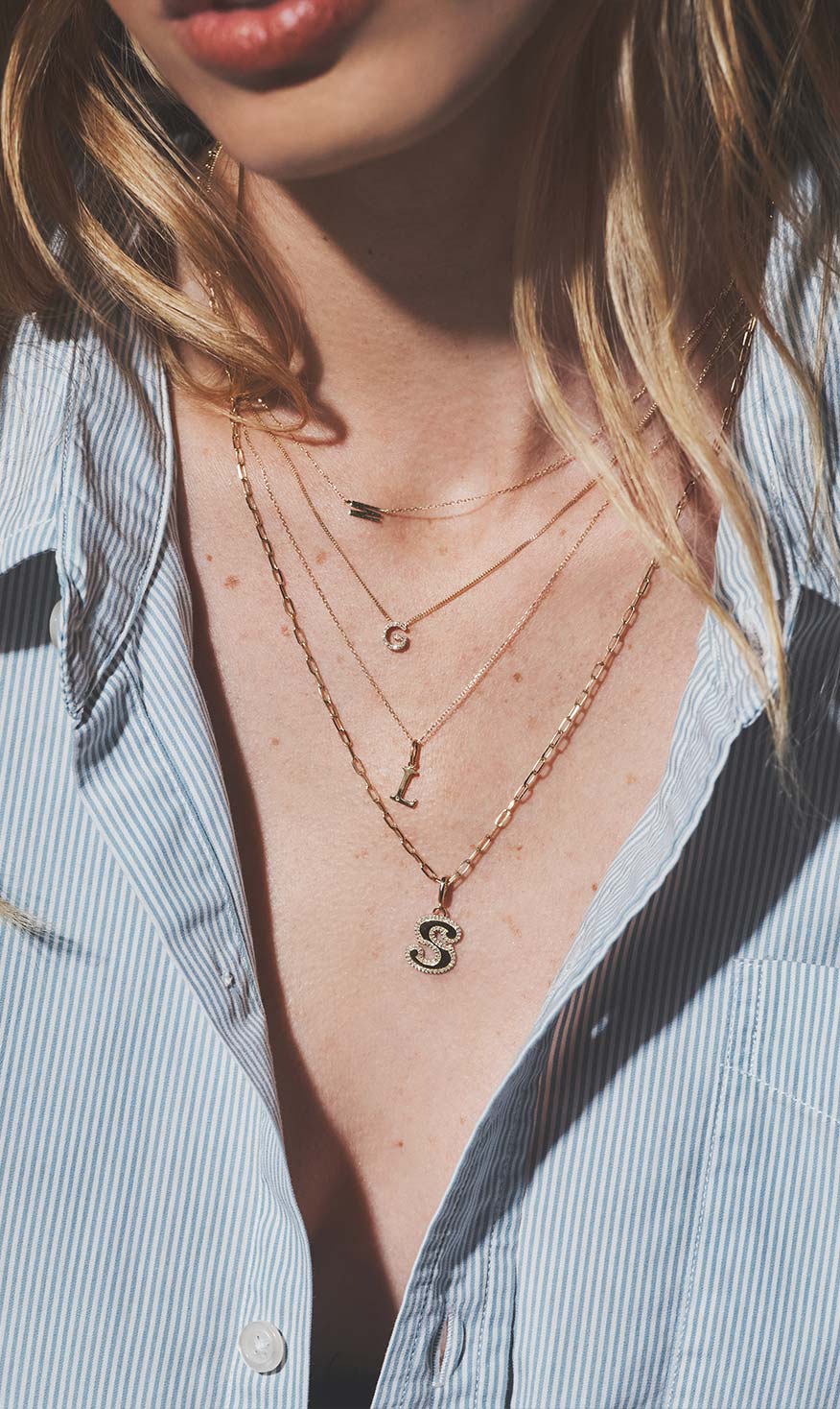 woman in gold stacked necklaces
