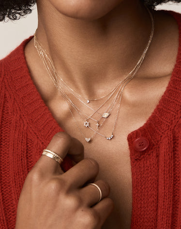 woman stacked in 14k gold diamond necklaces