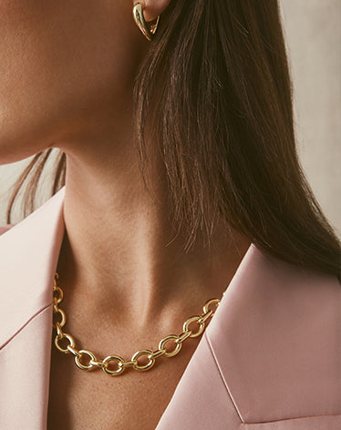 woman wearing chunky gold chain necklace
