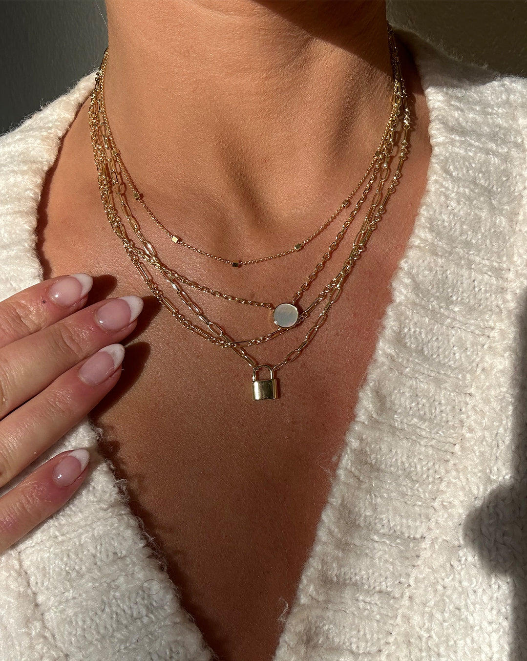 woman wearing gold plated necklaces